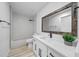 Updated bathroom with a white vanity, wood framed mirror, and modern black fixtures at 9748 Sw 74Th Ave, Ocala, FL 34476