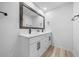 Bathroom featuring double vanity, framed mirror, and hardwood flooring at 9748 Sw 74Th Ave, Ocala, FL 34476