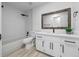 Bathroom featuring new white vanity, light tile walls, dark fixtures, and a tub at 9748 Sw 74Th Ave, Ocala, FL 34476