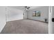 Carpeted bedroom featuring a window overlooking trees, closet, and a ceiling fan at 9748 Sw 74Th Ave, Ocala, FL 34476