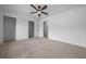 Large carpeted bedroom featuring a ceiling fan and access to a large walk-in closet at 9748 Sw 74Th Ave, Ocala, FL 34476