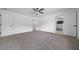 Large carpeted bedroom with ceiling fan, large closet, and an en-suite bathroom at 9748 Sw 74Th Ave, Ocala, FL 34476