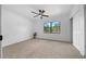 Spacious bedroom features a ceiling fan, plush carpet, a large window and a closet at 9748 Sw 74Th Ave, Ocala, FL 34476