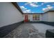 Charming entryway features a striking red door, stone details, and manicured plants at 9748 Sw 74Th Ave, Ocala, FL 34476