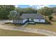 Charming single-story home with a striking red front door and mature palm tree at 9748 Sw 74Th Ave, Ocala, FL 34476