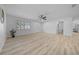 Inviting living room showcasing light wood floors, neutral walls, modern lighting, and a bright, airy feel at 9748 Sw 74Th Ave, Ocala, FL 34476