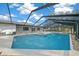 Inviting screened-in pool area featuring a spa and ample patio space for lounging at 9748 Sw 74Th Ave, Ocala, FL 34476