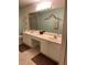 Double vanity bathroom with a large mirror at 9827 Sw 96Th St, Ocala, FL 34481