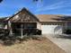 Front view of a single story house with a two-car garage at 9827 Sw 96Th St, Ocala, FL 34481