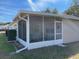 Screened porch with seating area and yard view at 9827 Sw 96Th St, Ocala, FL 34481