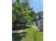 Large backyard featuring mature trees and green grass at 10245 Sw 105Th St, Ocala, FL 34481