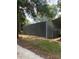 Exterior view of a large gray barn with a metal roof on a property with mature trees at 10245 Sw 105Th St, Ocala, FL 34481