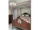 Cozy bedroom featuring a canopy bed, wood-style floors and a view to the closet at 10245 Sw 105Th St, Ocala, FL 34481