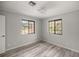 Bedroom with wood-look flooring and two windows with natural light at 10245 Sw 105Th St, Ocala, FL 34481