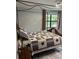 Charming bedroom with a canopy bed, stylish linens, and a window view at 10245 Sw 105Th St, Ocala, FL 34481