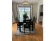 Bright dining room featuring hardwood floors, stylish lighting, and a view of the outdoor space at 10245 Sw 105Th St, Ocala, FL 34481