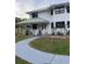 Exterior front view of the home with a sidewalk and a white porch with gray stairs at 10245 Sw 105Th St, Ocala, FL 34481