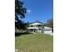 Two-story home with attached garage and wrap around porch sits on spacious lawn with lots of mature trees at 10245 Sw 105Th St, Ocala, FL 34481