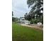 Spacious home with an attached garage, a large front yard, and mature trees at 10245 Sw 105Th St, Ocala, FL 34481