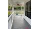 Inviting front porch with a ceiling fan and grey flooring offering a relaxing outdoor space at 10245 Sw 105Th St, Ocala, FL 34481