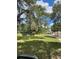 Spacious front yard featuring mature trees and a charming two-story home at 10245 Sw 105Th St, Ocala, FL 34481