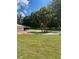 Wide front lawn with driveway and a beautiful set of three palm trees at 10245 Sw 105Th St, Ocala, FL 34481