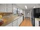 Functional kitchen featuring white cabinetry, neutral countertops, and a window over the sink at 10245 Sw 105Th St, Ocala, FL 34481