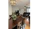 Open-concept living area showcasing a leather sectional, dining table, and lots of natural light at 10245 Sw 105Th St, Ocala, FL 34481