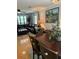 Open-concept living area showcasing a leather sectional, dining table, and lots of natural light at 10245 Sw 105Th St, Ocala, FL 34481