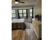 Main bedroom featuring a large window, wood flooring, and neutral decor at 10245 Sw 105Th St, Ocala, FL 34481