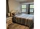 Comfortable main bedroom with a queen-sized bed, soft lighting and view of the outdoors at 10245 Sw 105Th St, Ocala, FL 34481