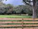 Open pasture with wooden fence and distant trees at 10245 Sw 105Th St, Ocala, FL 34481