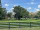 Idyllic horse pasture with mature trees and a sturdy wooden fence at 10245 Sw 105Th St, Ocala, FL 34481