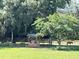 Scenic pasture with a hay feeder and horse grazing under a shade tree at 10245 Sw 105Th St, Ocala, FL 34481