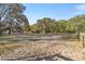 View of a large pasture with mature trees and a wooden fence at 10245 Sw 105Th St, Ocala, FL 34481