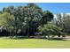 Horse feeder in a large green pasture with trees at 10245 Sw 105Th St, Ocala, FL 34481