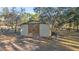 Detached storage shed with double wooden doors at 10245 Sw 105Th St, Ocala, FL 34481