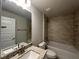 Modern bathroom features tiled shower-tub and vanity with granite countertop and brushed metal fixtures at 10927 Sw 41St Ave, Ocala, FL 34476