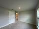 Comfortable bedroom with carpet flooring, a closet, and a view from the window at 10927 Sw 41St Ave, Ocala, FL 34476