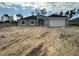 New construction home showcasing a modern design, gray exterior paint, and an attached two-car garage at 10927 Sw 41St Ave, Ocala, FL 34476