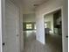 Bright foyer showcasing an open floor plan, tile flooring, and a view into the living area and kitchen at 10927 Sw 41St Ave, Ocala, FL 34476