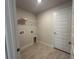 Functional laundry room with tile flooring and a wire shelf for storage at 10927 Sw 41St Ave, Ocala, FL 34476