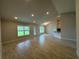 Bright living room with large windows, tile floors, and an open view to the kitchen at 10927 Sw 41St Ave, Ocala, FL 34476