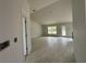 Spacious living room with tile flooring, ample natural light, and an open floor plan at 10927 Sw 41St Ave, Ocala, FL 34476