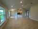 Open-concept living area with tile floors, recessed lights, and a view of the modern kitchen at 10927 Sw 41St Ave, Ocala, FL 34476