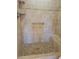 Bathroom with tiled shower and built-in seat at 10973 Sw 86Th Ct, Ocala, FL 34481