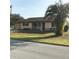 Single-story home with a palm tree and well-maintained lawn at 10973 Sw 86Th Ct, Ocala, FL 34481