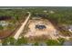 Aerial view of a new construction home on a large lot surrounded by lush trees at 11910 Sw 43Rd Street Road, Ocala, FL 34481