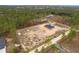 Aerial view of a new home under construction, nestled among mature pine trees on a sprawling lot at 11910 Sw 43Rd Street Road, Ocala, FL 34481