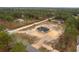 New construction home with a long driveway in a wooded area and a spacious lot ready for landscaping at 11910 Sw 43Rd Street Road, Ocala, FL 34481